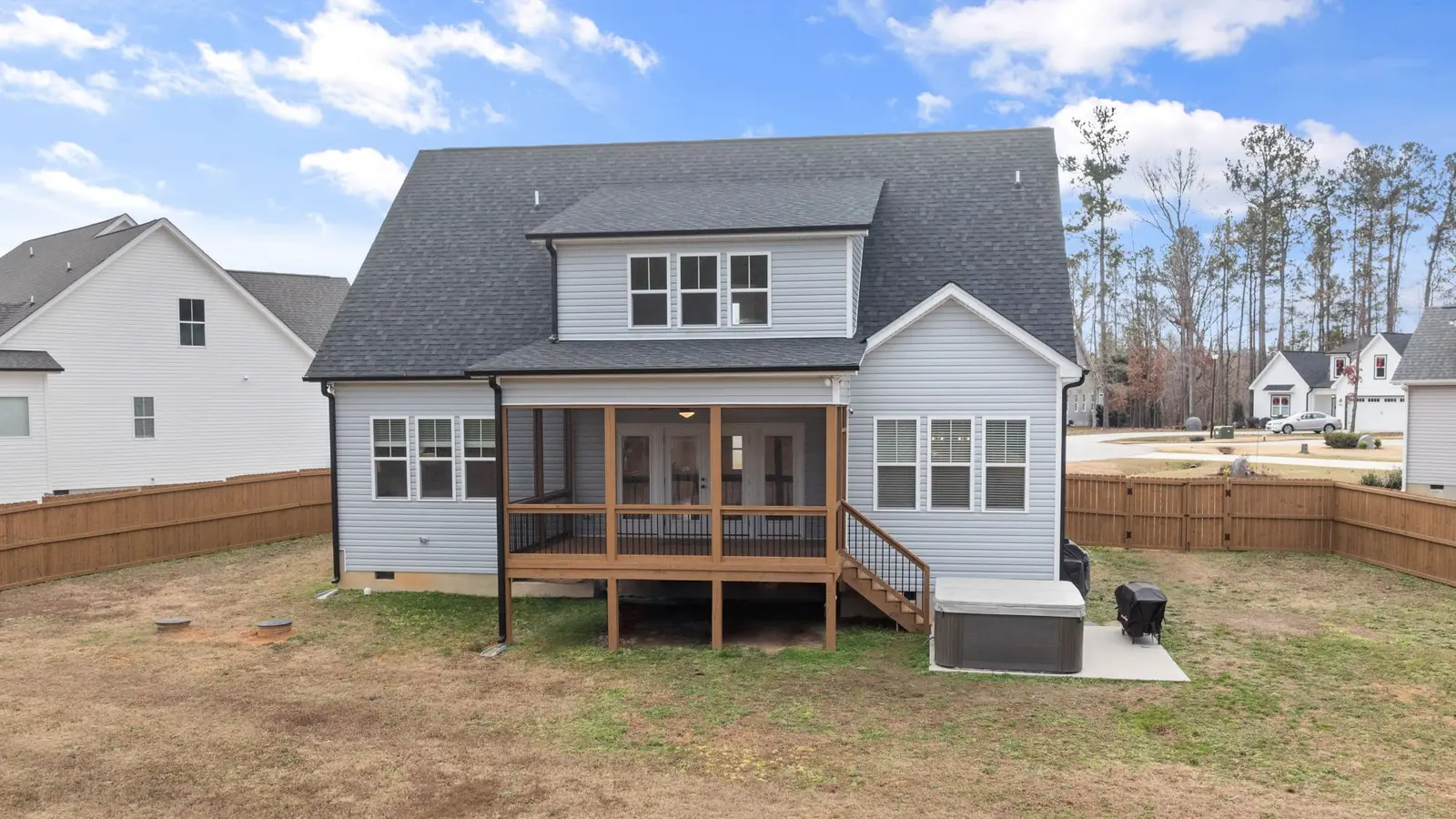 Two-story house with a raised screened porch and a fenced backyard